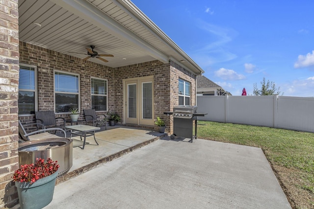 view of patio / terrace with a grill, fence, and a ceiling fan