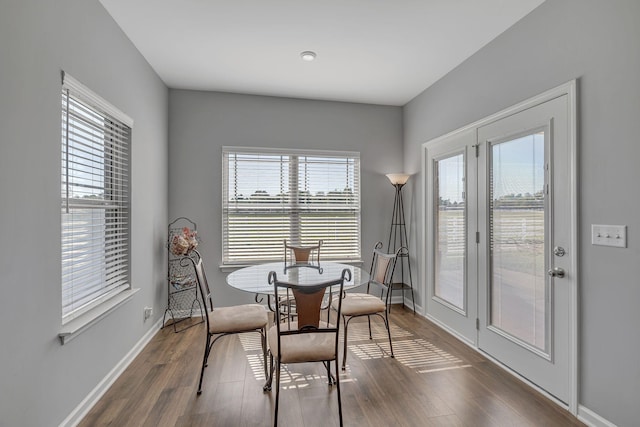 dining room with dark wood-type flooring and baseboards