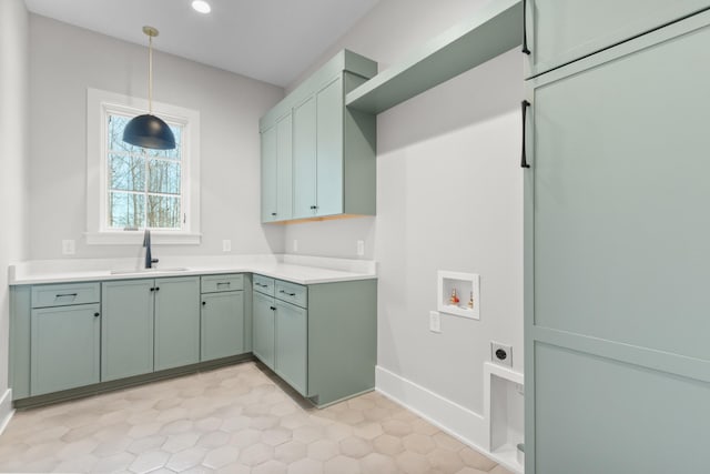 laundry room featuring electric dryer hookup, a sink, cabinet space, baseboards, and hookup for a washing machine