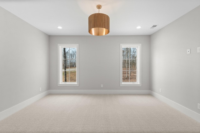 spare room featuring recessed lighting, baseboards, visible vents, and light carpet