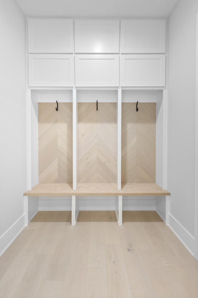 mudroom with light wood-style floors and baseboards