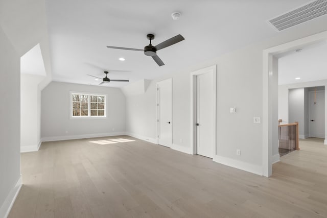 bonus room featuring visible vents, lofted ceiling, light wood-style floors, and baseboards