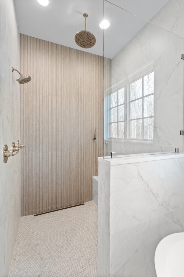 bathroom with a marble finish shower