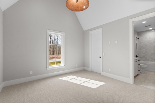 unfurnished bedroom featuring high vaulted ceiling, ensuite bathroom, recessed lighting, baseboards, and light colored carpet