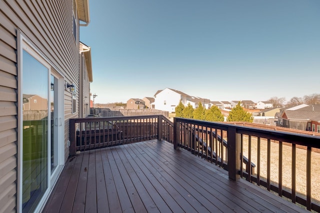 wooden deck featuring a fenced backyard and a residential view