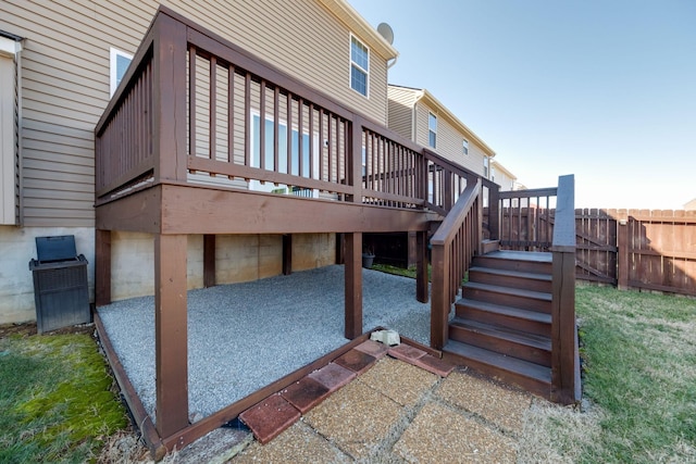 back of property with fence, stairway, and a deck