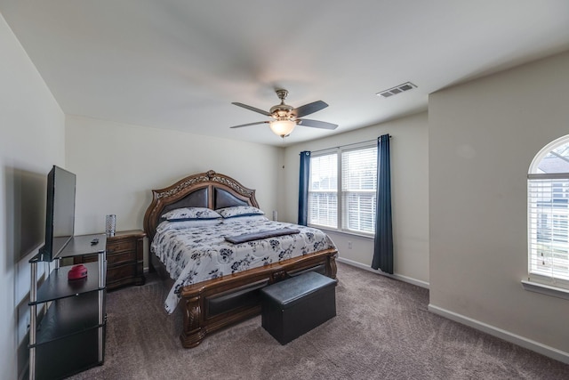 carpeted bedroom featuring visible vents, ceiling fan, and baseboards