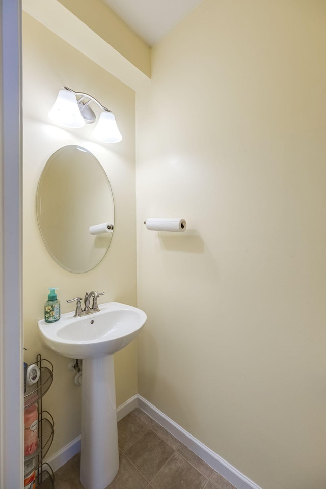 bathroom with tile patterned floors and baseboards