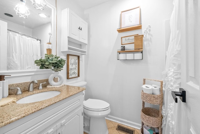 full bathroom with visible vents, toilet, vanity, baseboards, and tile patterned floors