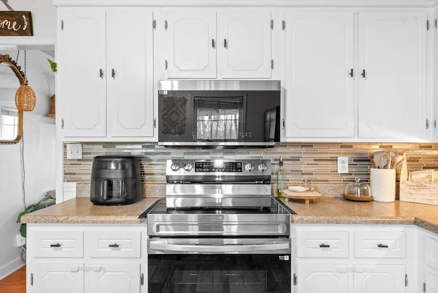 kitchen featuring white cabinetry, appliances with stainless steel finishes, light countertops, and backsplash