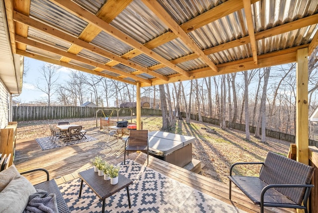 view of patio with a hot tub, a fenced backyard, a deck, and outdoor dining space