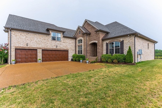 french provincial home featuring driveway, brick siding, a front lawn, and roof with shingles