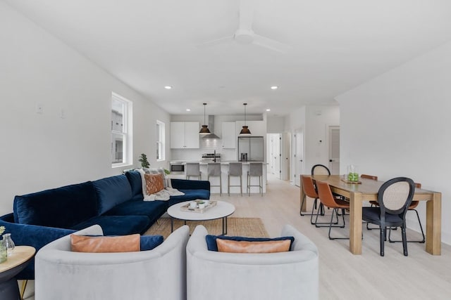 living room with ceiling fan, light wood finished floors, and recessed lighting