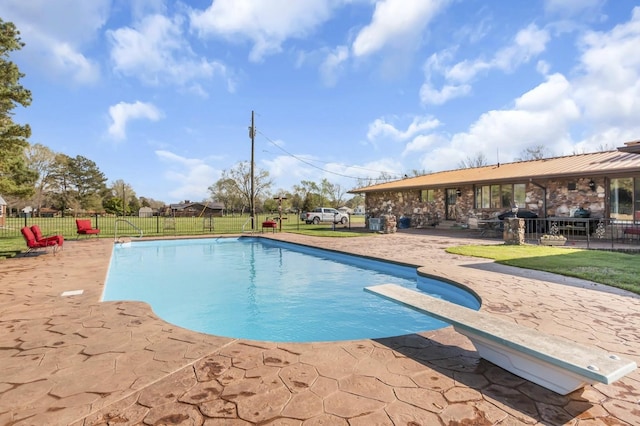 view of swimming pool featuring a patio area, a lawn, fence, and a fenced in pool