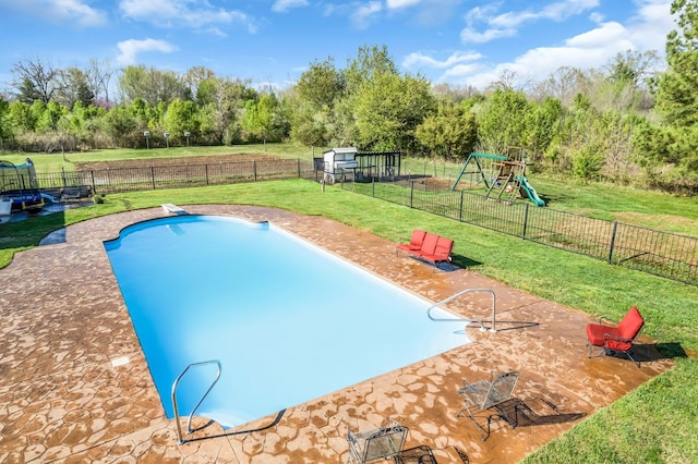 view of pool with a fenced backyard, a patio, a playground, and a yard