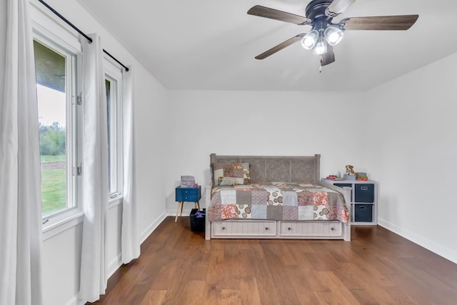 unfurnished bedroom with a ceiling fan, baseboards, and wood finished floors