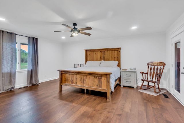 bedroom with dark wood-style floors, recessed lighting, visible vents, and baseboards