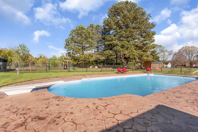 view of swimming pool with a fenced in pool, a playground, a patio, a lawn, and a fenced backyard