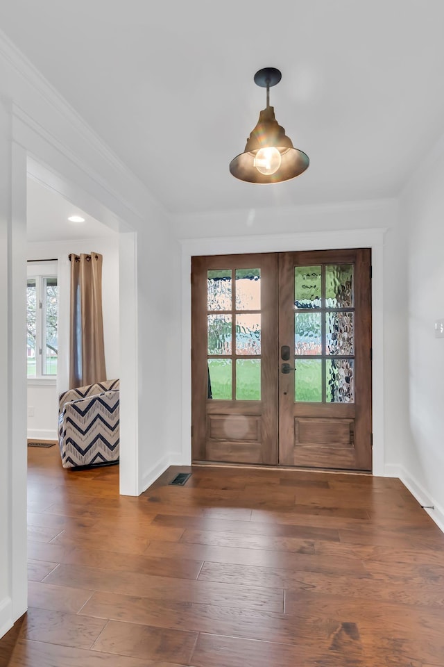 entrance foyer with baseboards, visible vents, hardwood / wood-style floors, and french doors