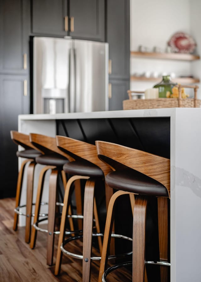 kitchen with stainless steel refrigerator with ice dispenser and wood finished floors