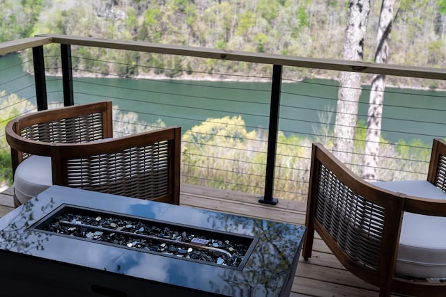 deck featuring a water view and a fire pit