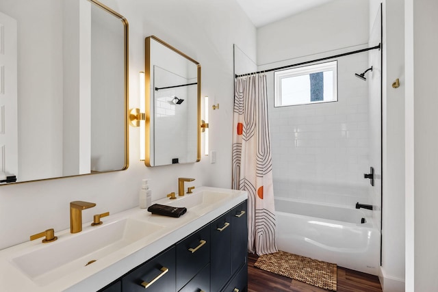 full bath featuring shower / bath combination with curtain, wood finished floors, a sink, and double vanity