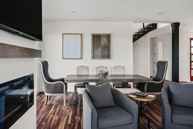 dining room featuring baseboards, stairway, and dark wood-style flooring