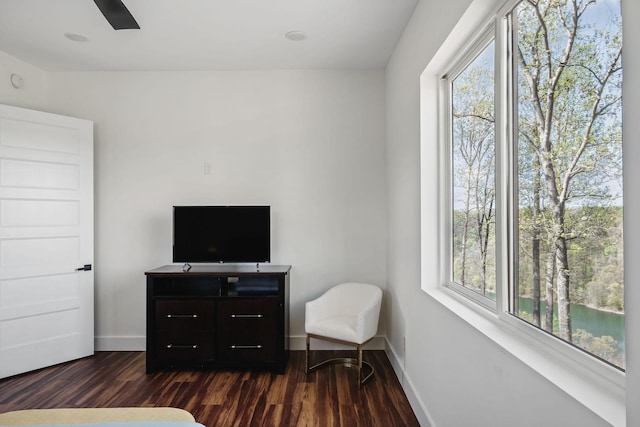 sitting room featuring baseboards and dark wood finished floors