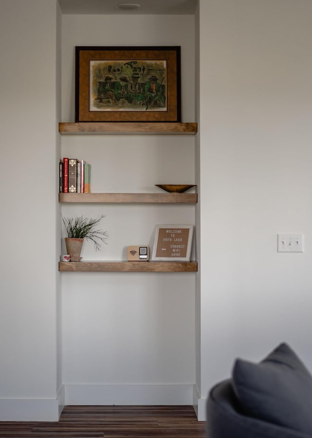 interior details with wood finished floors and baseboards