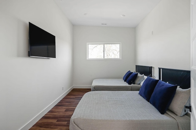 bedroom featuring baseboards and wood finished floors