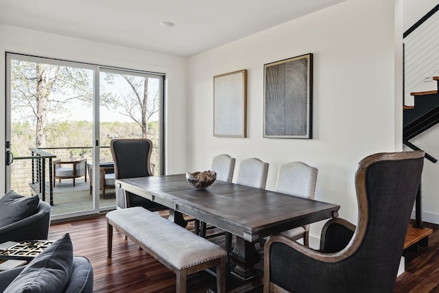 dining space featuring stairway and wood finished floors