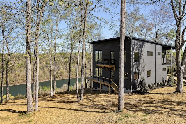 exterior space with a water view and stairway