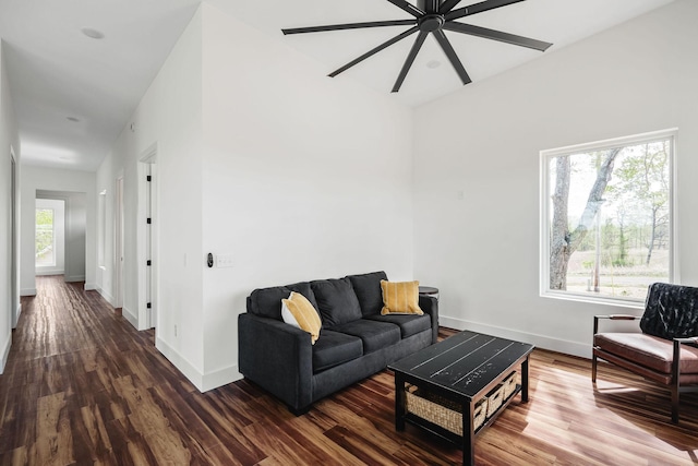 living area featuring baseboards and wood finished floors