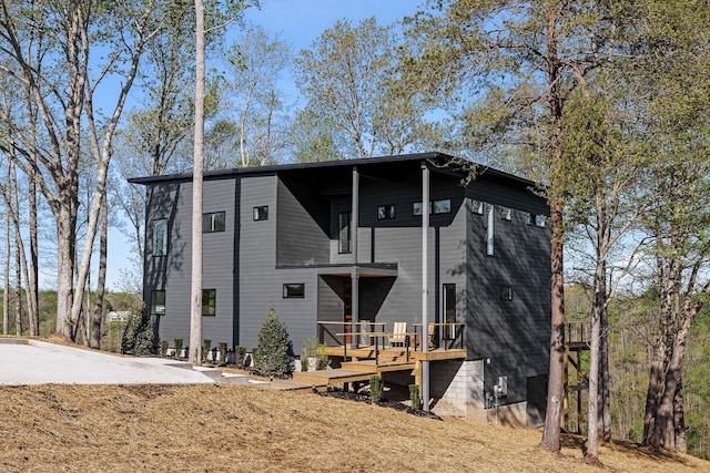 back of property with a wooden deck