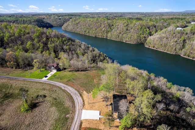 drone / aerial view with a water view and a wooded view