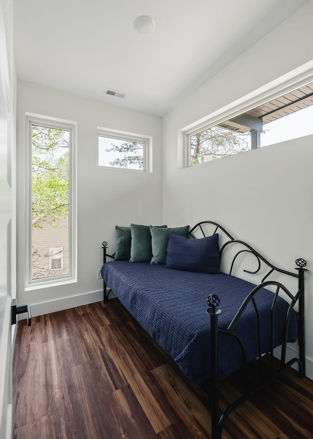 bedroom featuring dark wood-type flooring, visible vents, and baseboards