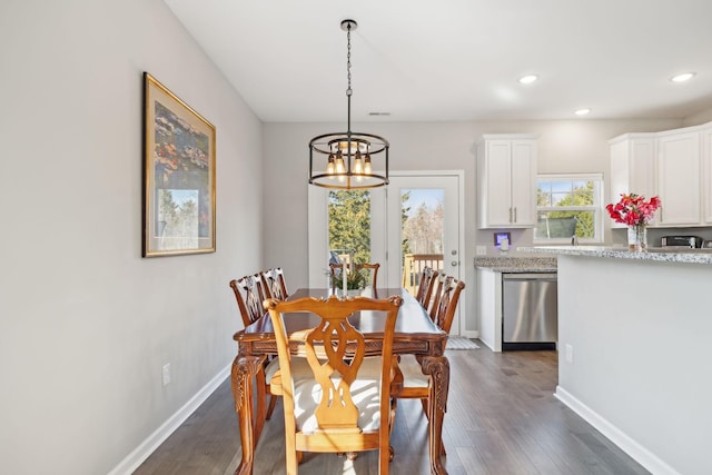 dining area featuring a chandelier, recessed lighting, dark wood finished floors, and baseboards