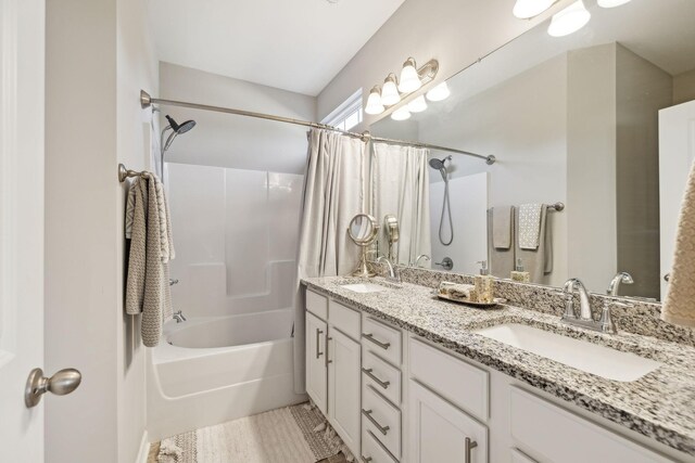 full bath with double vanity, shower / bath combo, and a sink