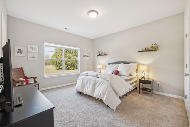 carpeted bedroom with visible vents and baseboards