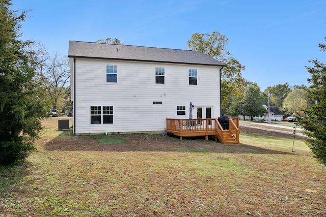 back of property with a deck, french doors, central AC unit, and a lawn