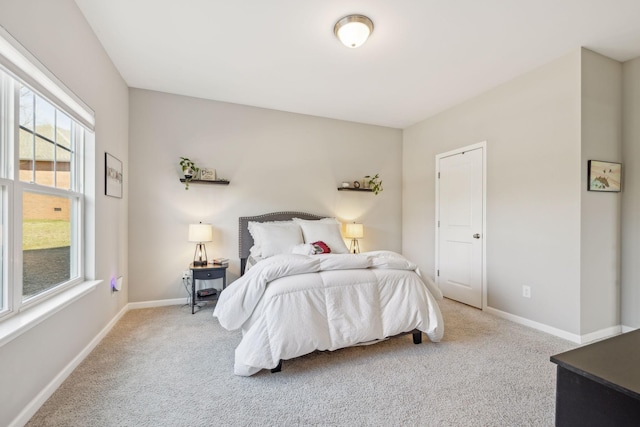 bedroom with carpet floors and baseboards