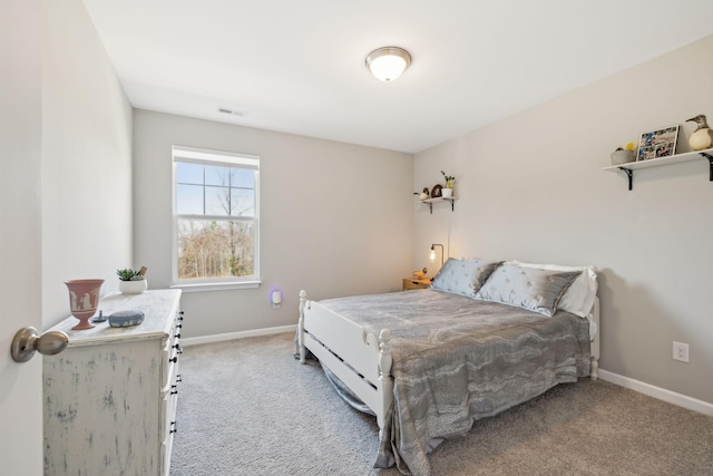 bedroom with carpet floors, visible vents, and baseboards