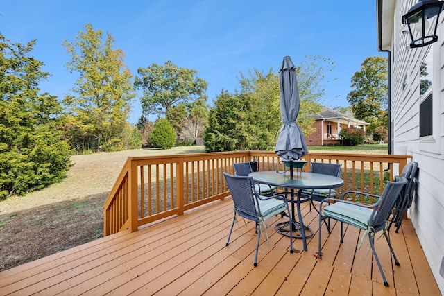 wooden deck featuring outdoor dining space