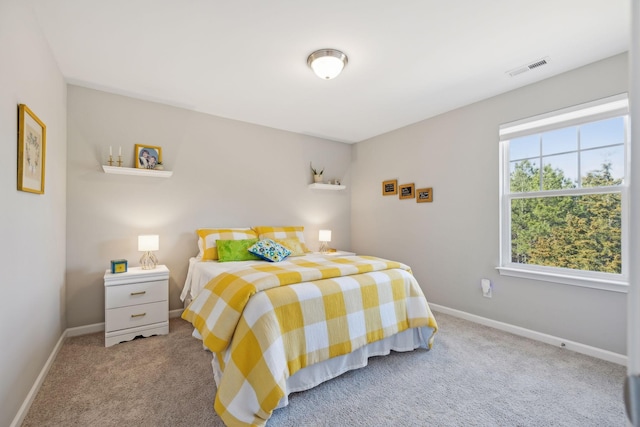 carpeted bedroom featuring visible vents and baseboards