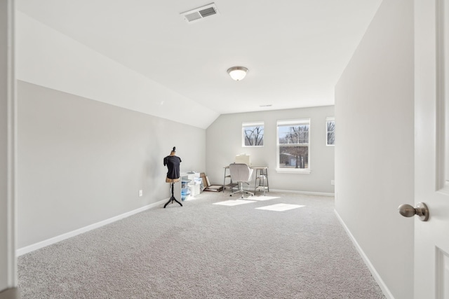 interior space with carpet floors, lofted ceiling, visible vents, and baseboards