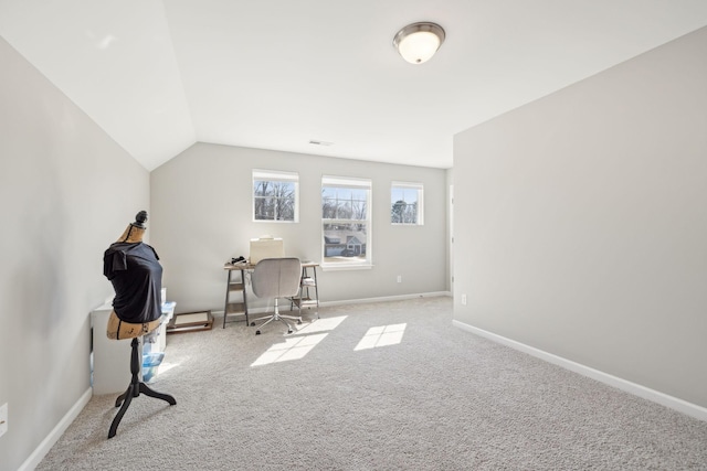 home office featuring lofted ceiling, carpet flooring, and baseboards