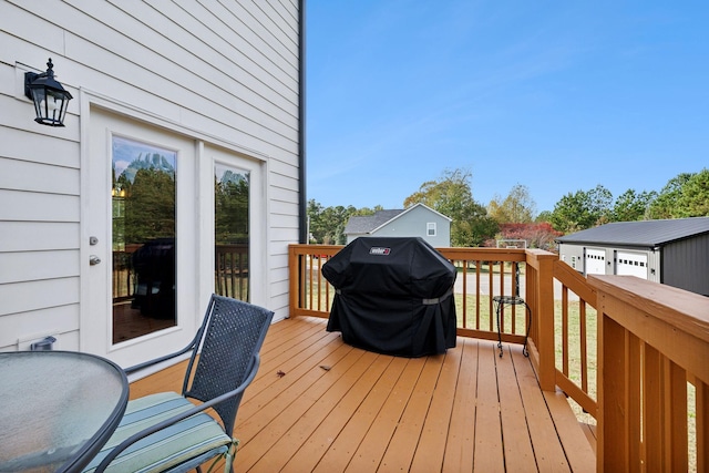 wooden deck featuring a grill