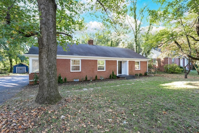 ranch-style home featuring brick siding, crawl space, a chimney, and a front yard