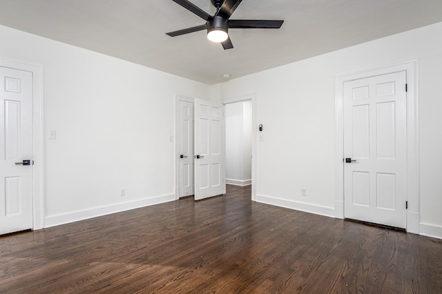 unfurnished bedroom featuring a ceiling fan, baseboards, and dark wood-style flooring