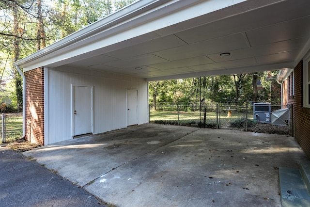 garage featuring driveway and fence